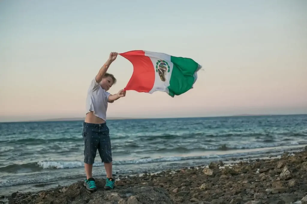 What time is it in Mexico? make traveler boy confused. he hold flag in his hand to enjoy the beautiful weather